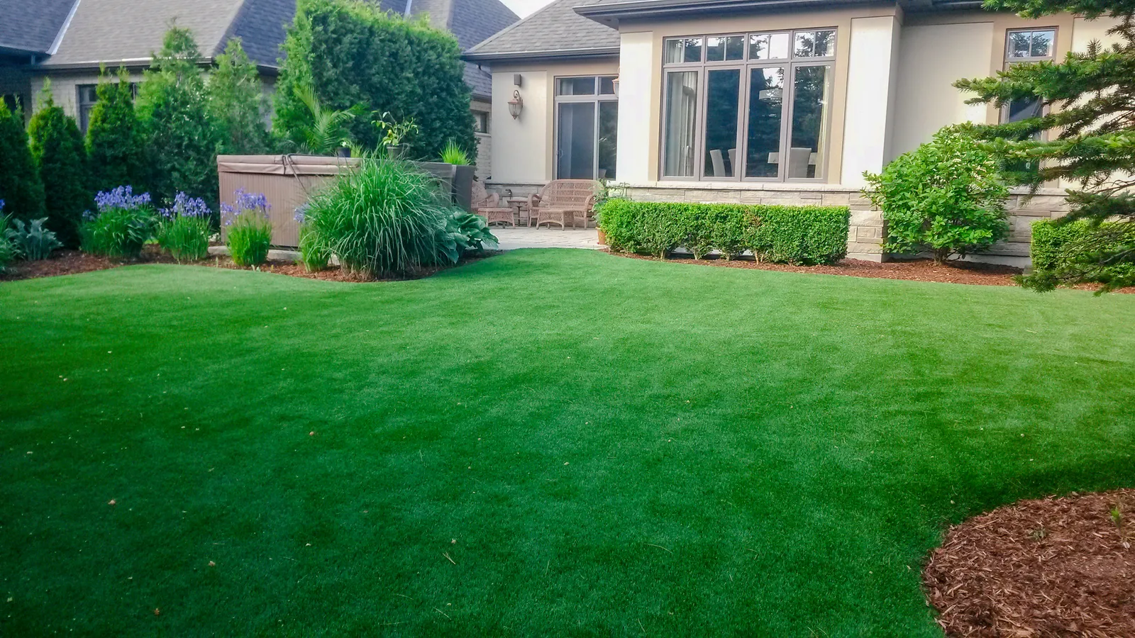 Landscaped yard with synthetic turf